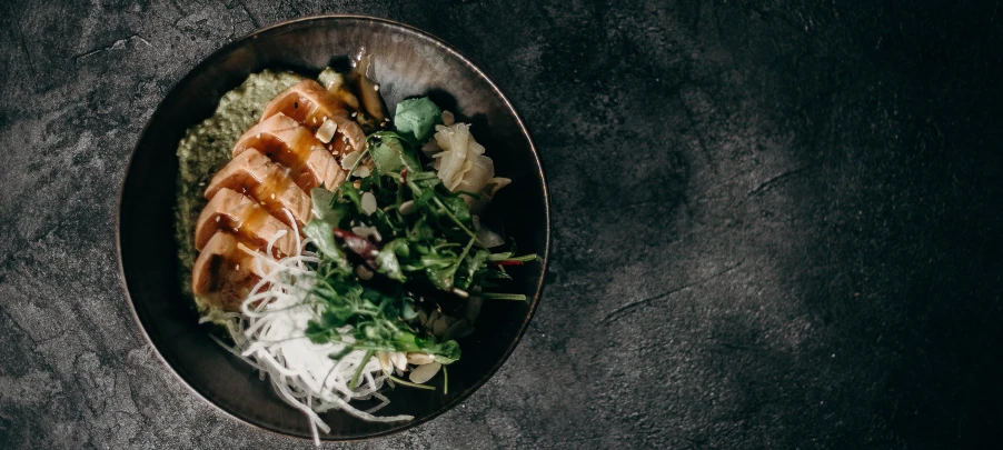 Prepared Arctic Char in a bowl with vegetables